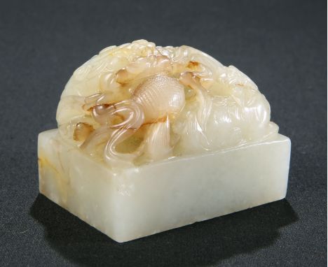 A CHINESE CELADON JADE SEAL, rectangular, the matrix with four Archaic type characters, surmounted by two carved fu dogs. 6cm