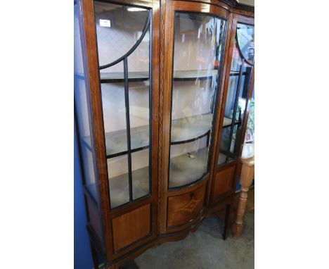 Edwardian mahogany inlaid three tier display cabinet, with central bowfront glazed panel flanked by two glazed cupboard doors