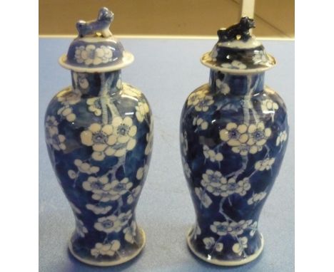 Pair of similar Chinese blue &amp; white blossom pattern vases with four digit signature panel to the base, the covers creste