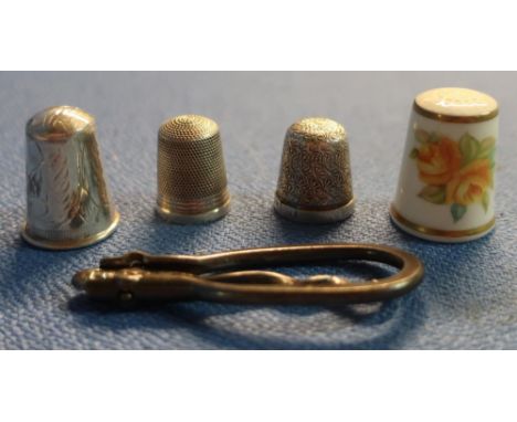 Three silver hallmarked thimbles, a folding button hook and a Royal Worcester thimble (5) 