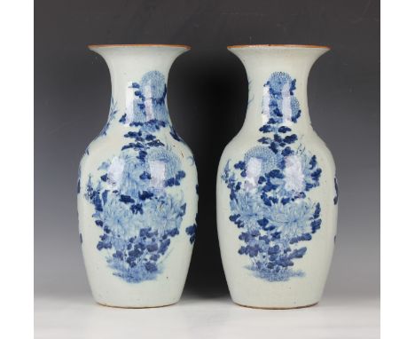 A pair of Chinese blue and white porcelain vases, late 19th/early 20th century, each shouldered tapering body and flared neck