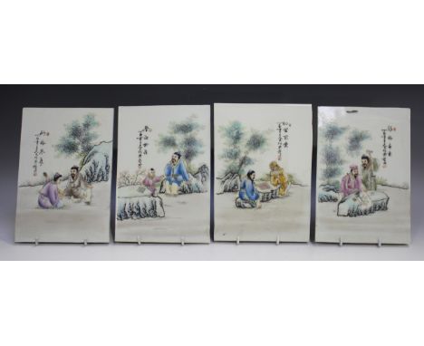 A set of four Chinese famille rose porcelain rectangular plaques, 20th century, each painted with a figural scene beside two 