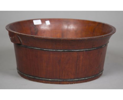 A Chinese stained wooden basin of slightly flared circular coopered form, diameter 47cm.Buyer’s Premium 29.4% (including VAT 