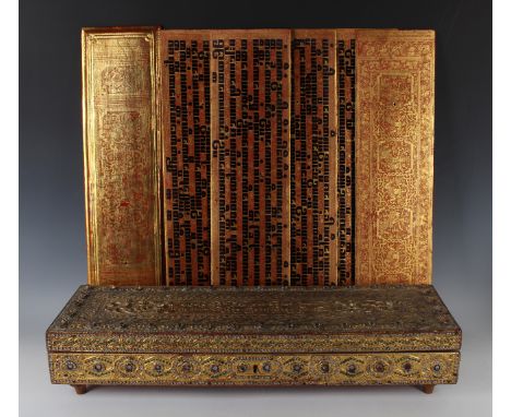 A Burmese red, black and gilt lacquered Kammavaca manuscript, late 19th century, comprising two rectangular covers and sixtee
