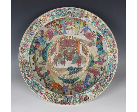 A Chinese Canton famille rose porcelain circular basin, mid-19th century, the interior painted with figural scenes within a r