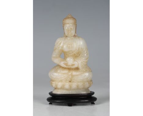 A Chinese carved pale celadon jade figure of Buddha, 20th century, modelled seated in dhyanasana on a lotus throne base, heig