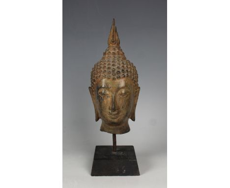 A Thai bronze Buddha head, 19th/20th century, modelled with tightly curled hair rising to a domed unisa and flame surmount, h