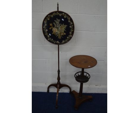 AN EARLY 20TH CENTURY REGENCY STYLE MAHOGANY POLE SCREEN, the floral tapestry on a black ground within a border, on a tripod 