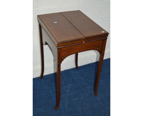AN EDWARDIAN MAHOGANY SATINWOOD BANDED AND STRUNG WRITING TABLE, double fold over top enclosing a rise and fall letter rack a