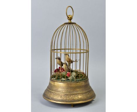 AN EARLY 20TH CENTURY CLOCKWORK AUTOMATON OF A CAGE OF THREE BIRDS, stamped brass base, on three turned feet, height approxim