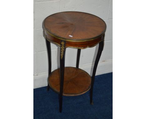 A 19TH CENTURY FRENCH CIRCULAR MAHOGANY OCCASIONAL TABLE, with brass mounts throughout, Kingwood veneer top and undershelf, a