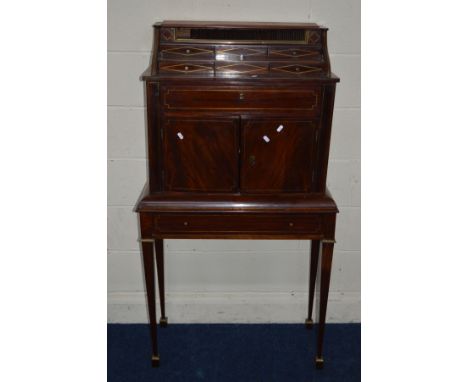 A REGENCY AND LATER MAHOGANY AND BRASS STRUNG CABINET ON STAND, the cascade top with a tambour door within brass banding abov