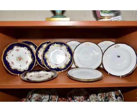 A SET OF SIX SPODE COPELANDS CHINA DESSERT PLATES, blue and gilt rims with gilt motto and crest, retailed through T Goode &am