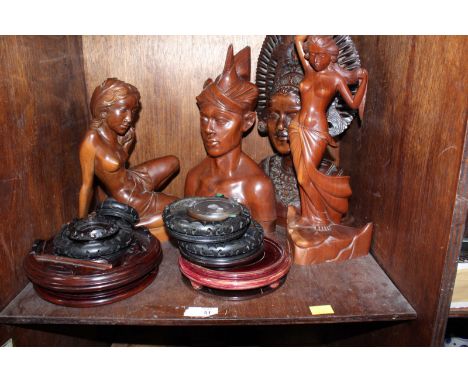 SECTION 51. A shelf of assorted carved hardwood busts from Bali and a collection of turned wooden vase stands.