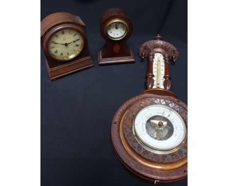 An aneroid barometer in walnut case, together with two small mahogany-cased mantel clocks.  (3)  