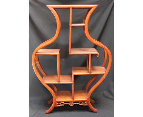 An Oriental carved hardwood freestanding shelf unit. 69 cm high.