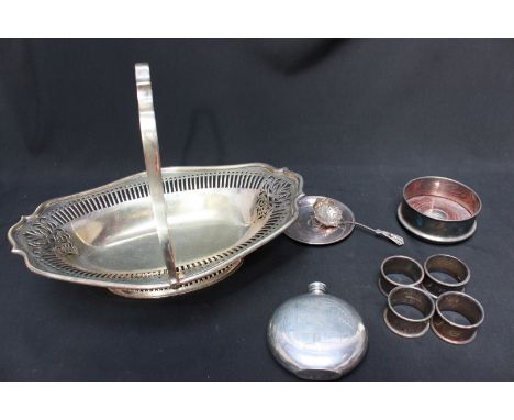 A silver plated bread basket, together with four napkin rings, a hip flask, bottle coaster, tray and a silver sifter spoon.