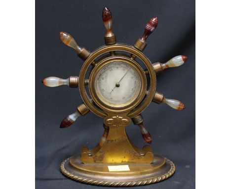 A Victorian brass and agate ships wheel barometer by Trussell of Brighton, the handles of the wheel formed from turned banded