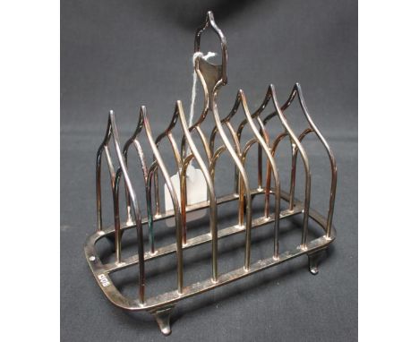 An Edwardian silver six division toast rack, hallmarked London 1905, with Gothic arch divisions, makers mark: William Hutton 