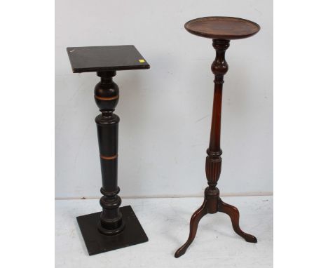A stained-wood torchere stand with circular dished top, turned column, tripod base, together with an ebonised turned torchere