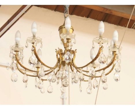 A large brass and cut glass 10 light chandelier, together with three matching wall lights.