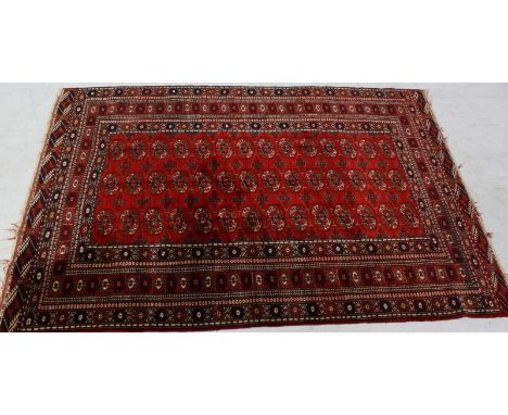 A Persian Bokhara rug, decorated with a central panel of rows of gulls, surrounded by geometric borders. 182 x 126 cm.