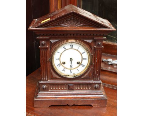 A Victorian oak cased mantle clock with Gothic arched case and white enamel dial with black Roman numerals. 39 cm high.