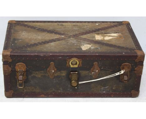 A metal-bound cabin trunk with papered interior and internal storage box, partial White Star Line label.