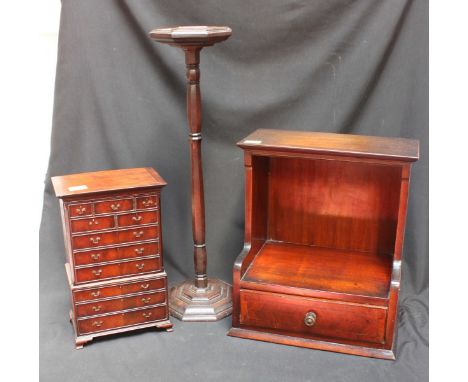 A novelty stationery box modelled miniature mahogany chest on chest, together with a small open book shelf with single drawer