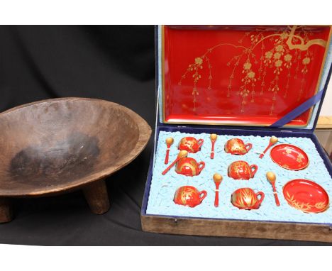 A Japanese red and gilt lacquer tea set, comprising six cups, saucers and spoons, on a rectangular tray, in a fitted case. To