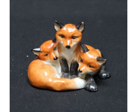A Royal Worcester group of three seated fox cubs, mark in black to base, circa 1950.