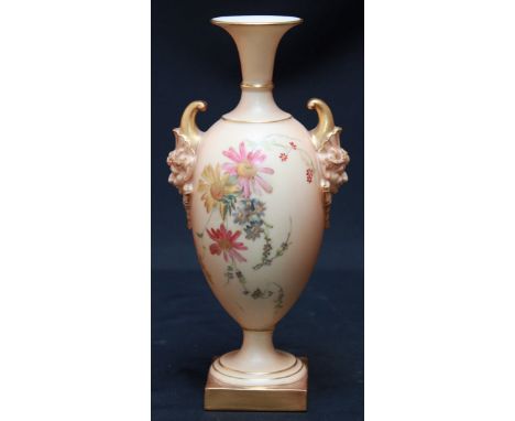 A Victorian Royal Worcester blush ivory vase, the ovoid body painted with flowers, with mask handles and supported on a pedes