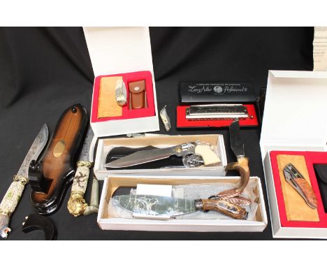 A collection of collectors knives, some with Damascus blades, together with a box camera and a harmonica.