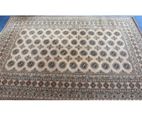 A large machine made beige and gold Mossoul carpet.222 x 298 cm.