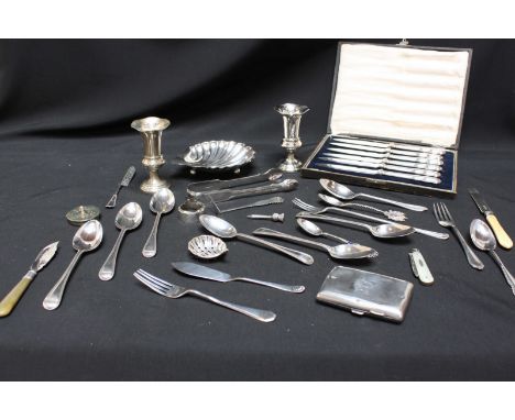 A collection of silver including a set of six tea spoons, a small pair of vases, a shell shaped silver dish, a case set of ca