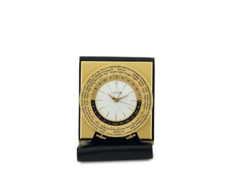 Luxor, gilt brass table clock with alarm and 24 hours indication with a revolving disc with the name of the cities of the wor