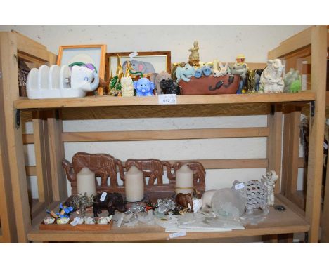 Quantity of carved models of elephants in ceramic and metal and also some candles with elephant moulded tray