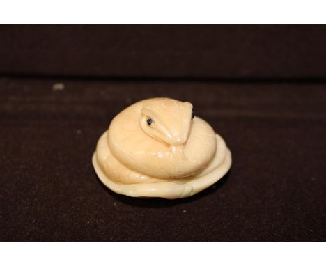 An antique hand carved netsuke, signed to the base 4.5cm in diameter 