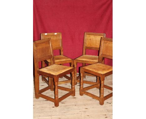 Four Robert (Mouseman) Thompson late 1950's early 60's oak dining chairs with the trademark mouse on one leg, with original l