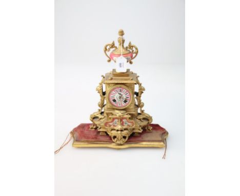 A French late 19th century gilt metal mantel clock, of Louis XV1 style, with pompadour pink and floral Sevres style mounts an