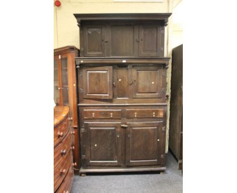 A part 18th century oak tridarn, having a moulded pediment over two stages, each with a pair of fielded panel doors, the base