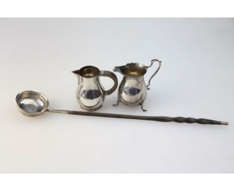 A George III silver toddy ladle, coin set bowl and silver tipped twisted whalebone handle, together with an Art Deco sparrow 