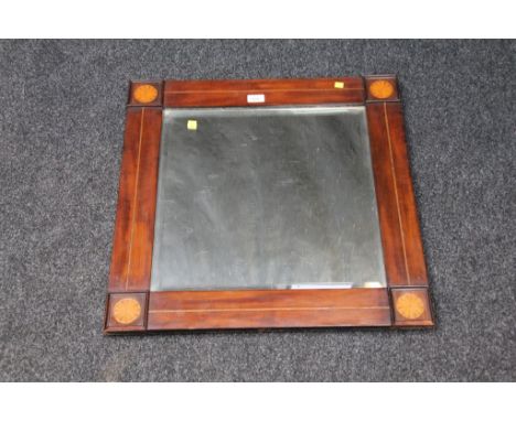 An Edwardian mahogany, boxwood fan inlaid and strung wall mirror, with moulded corner reserves and bevelled plate, 62 x 62 cm