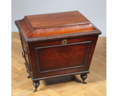 A late Regency/William IV mahogany cellarette, having a caddy top with gadrooned edge over conforming sides and brass ring ha