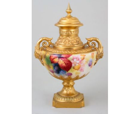 A Royal Worcester twin handled vase, having spear finial and domed cover over a shouldered baluster body with mask handles, d