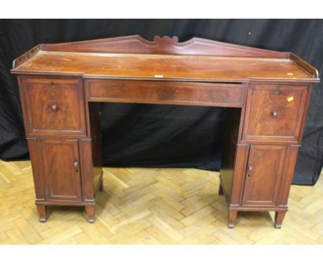 A William IV figured mahogany twin pedestal breakfast sideboard, with shaped gallery back, fitted one frieze drawer and two d