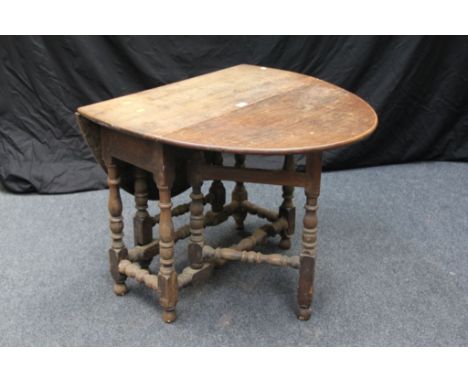 A late 17th century style oak, oval gate-leg table, with planked top, raised on baluster turned frame base, 87 cm (34 in) wid