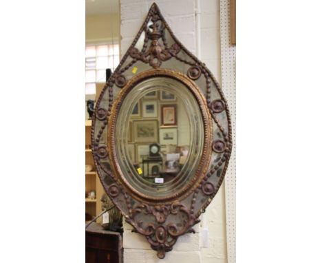 A 19th century carved and gilt gesso lozenge shaped Venetian wall mirror, the oval plate with moulded detail within swag and 