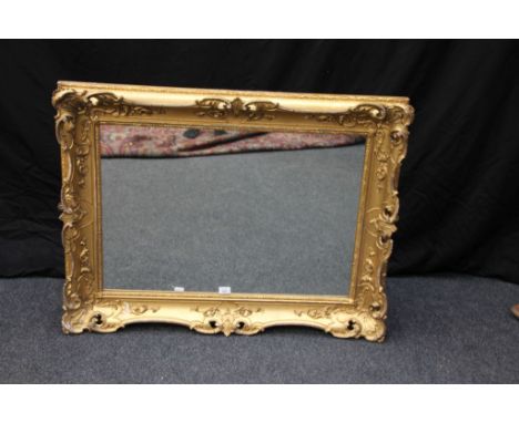 A 19th century carved and swept gilt frame, with pierced shell border, now fitted with a plain mirror plate, 82 x 106 cm (31 