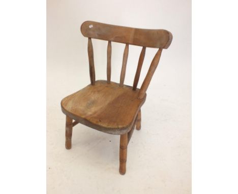 A childs stick back chair